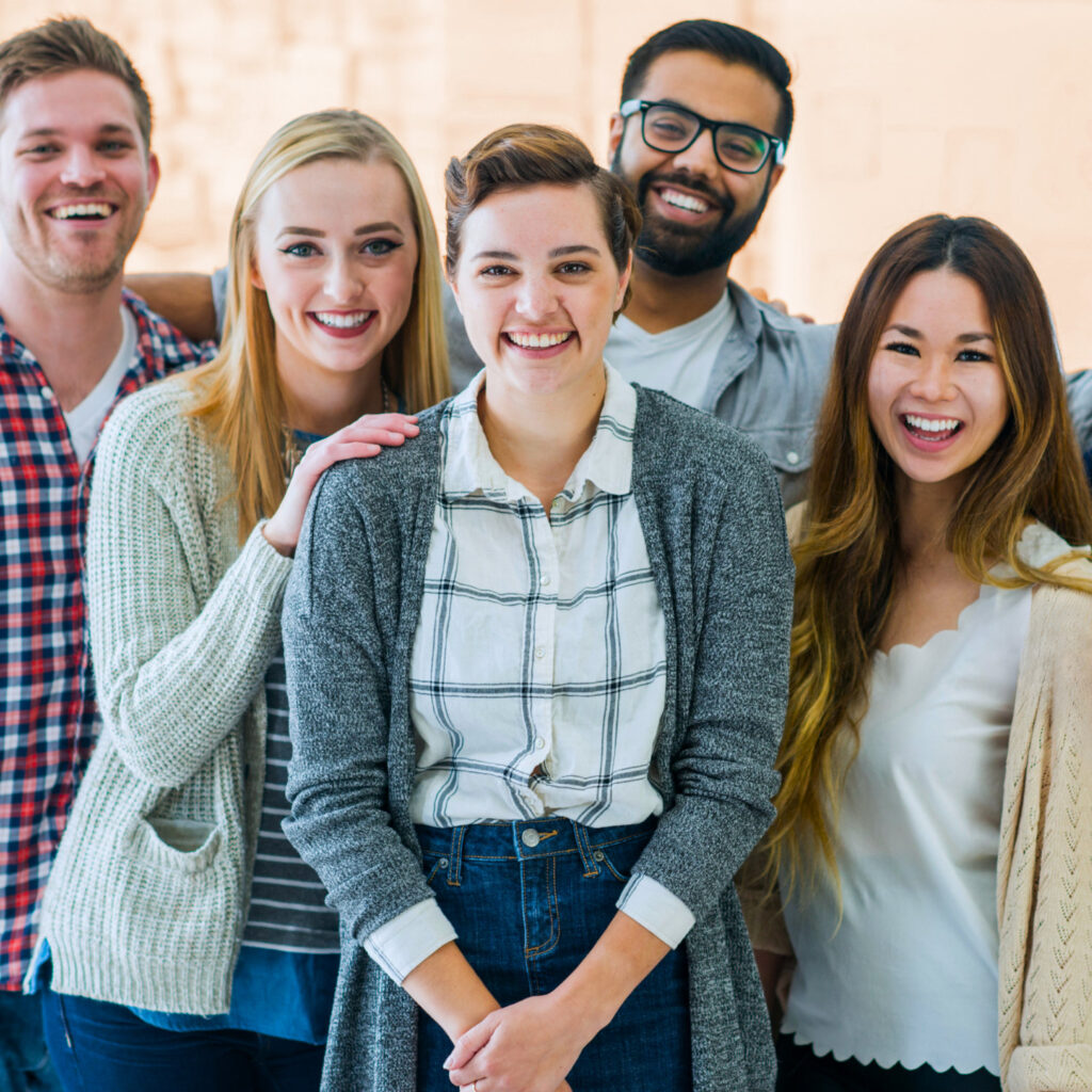 A female CEO is looking at the camera and smiling