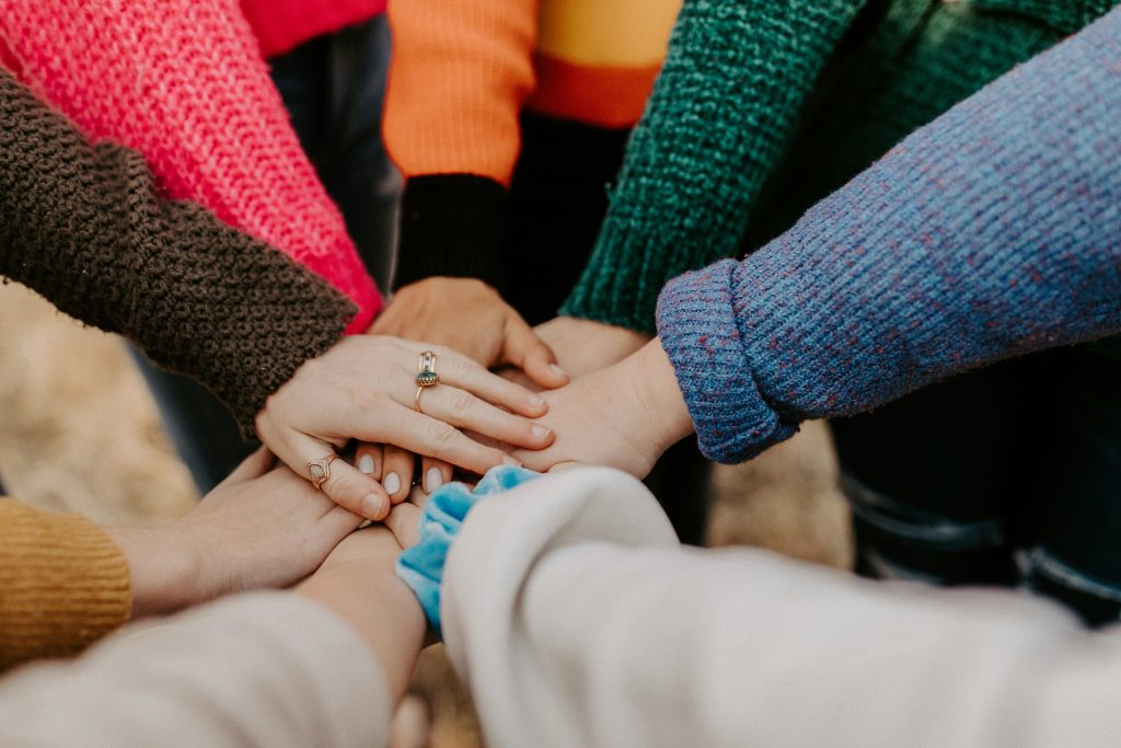 Image of feminine hands together in a circle. Image by Hannah Busing via Unsplash. Thanks Hannah.