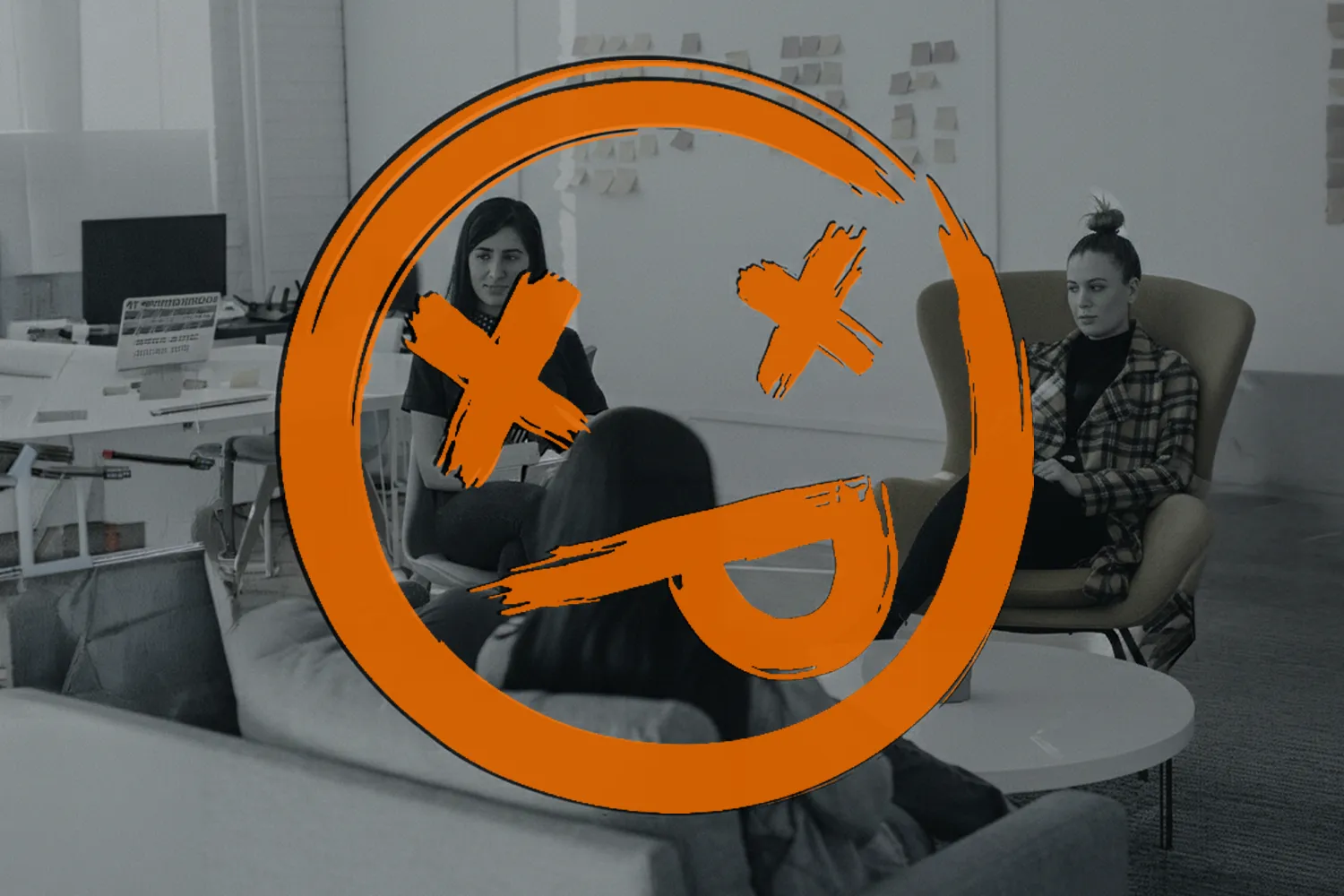 a picture of employees giving feedback in a room, the image is grey and has a dead face emoji overlaid